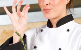 female chef with delicious hand sign